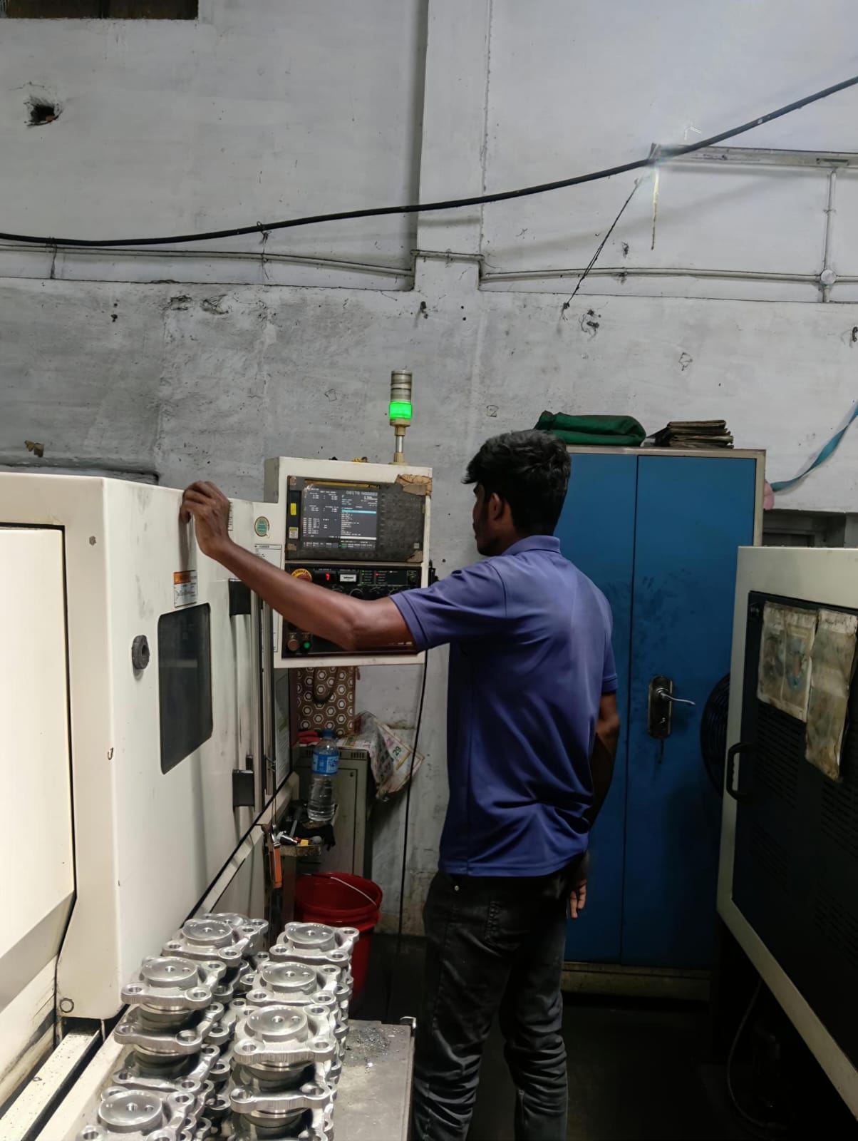 Experienced component technician adjusting setup parameters at station